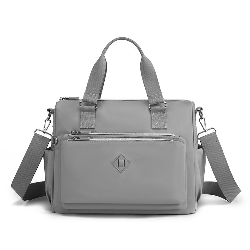 Waterproof nylon one-shoulder bag, gray, front view with two top handles