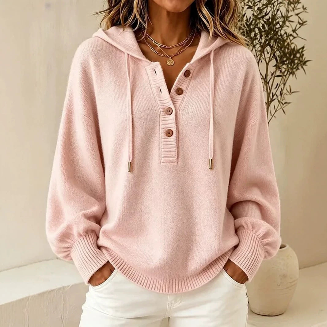 Pink hooded knit sweater with button placket, drawstring cords, and ribbed cuffs