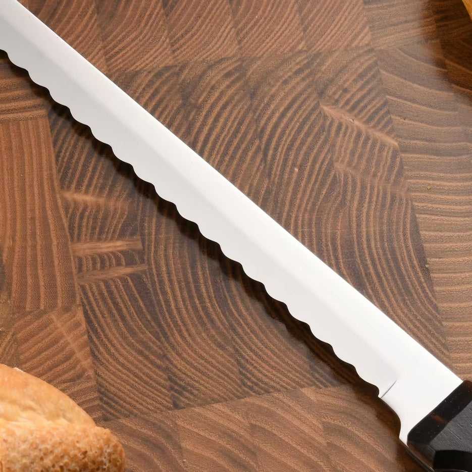 Polished carbon-steel bread knife blade with serrated edge and dark wood handle