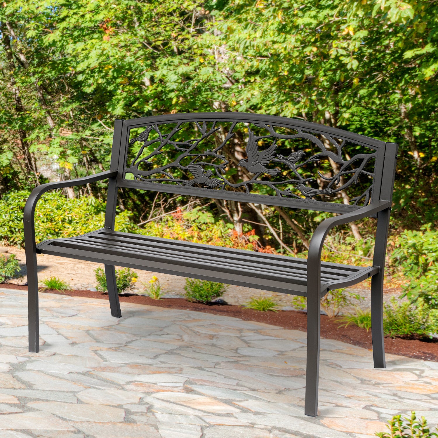 Brown cast iron garden bench with arched bird-and-branch backrest and slat seat