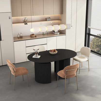 Black dining table with round top and ribbed pedestal base, set for four seats.