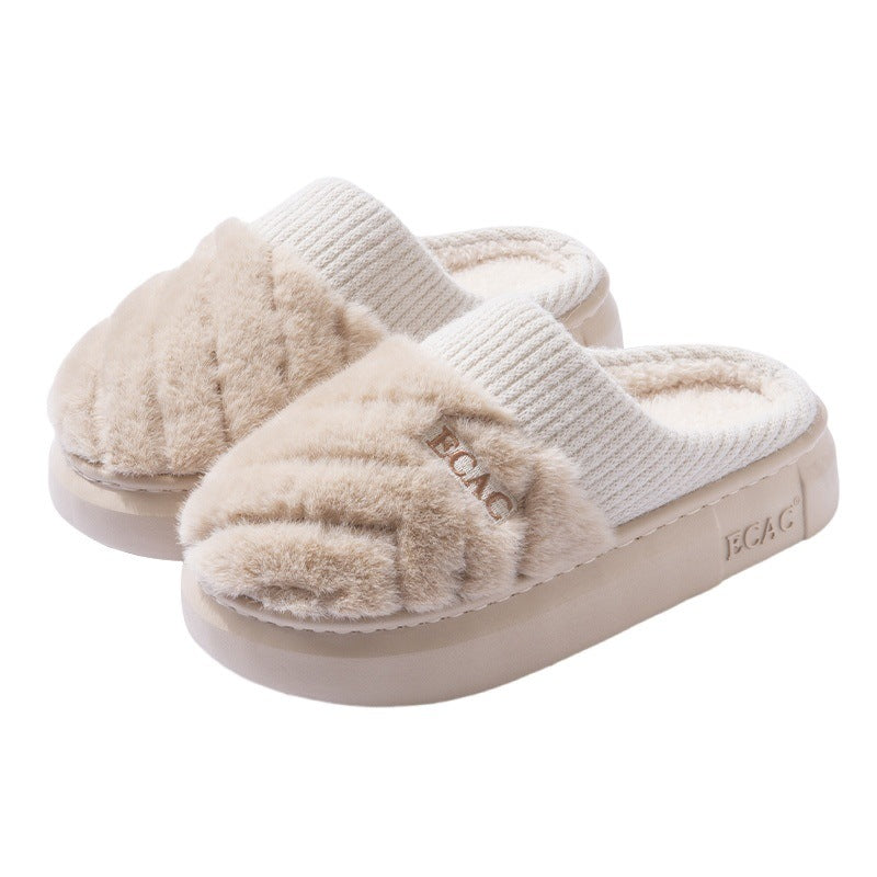 Pair of beige slippers with white soles on a white background