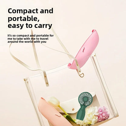 Pink handheld fan with circular grille and wrist strap attachment