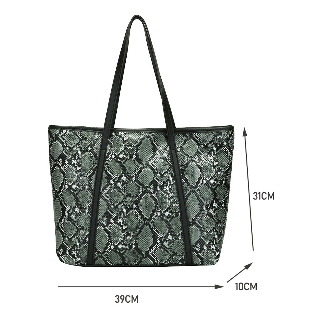 Large green snake-print tote bag with black trim and top handles; measurements shown