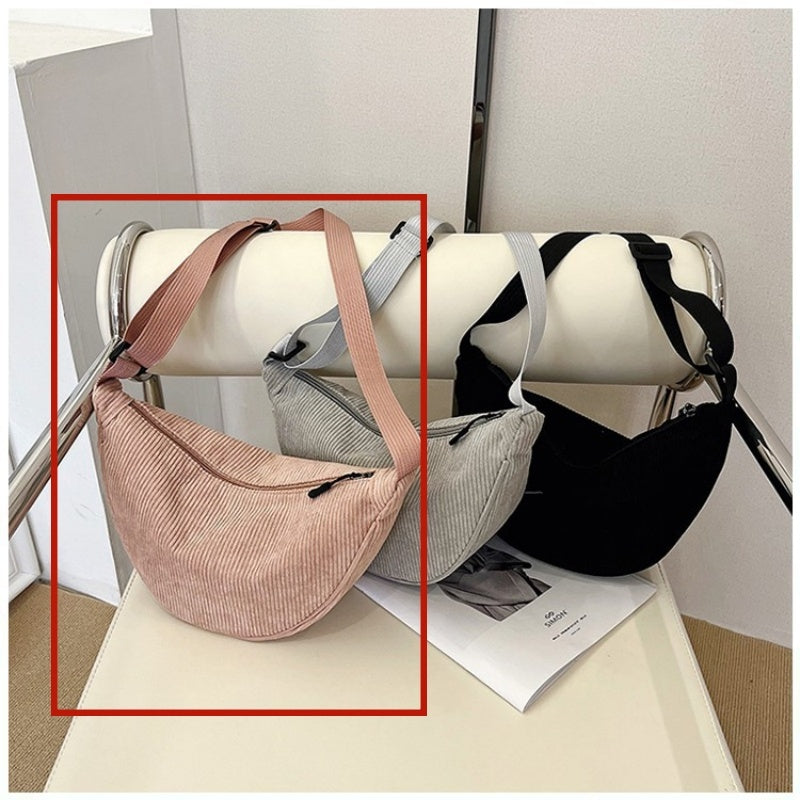 Large dumpling crossbody handbag in light brown with curved top and adjustable strap