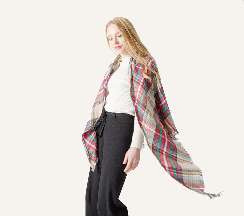 Plaid scarf close-up with woven texture, red and gray lines, beige base, fringed ends