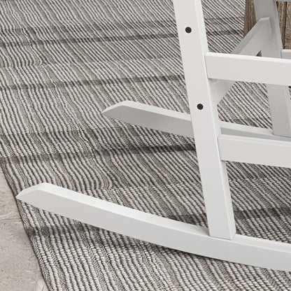 White wooden rocking chair base and side rail close-up over textured rug