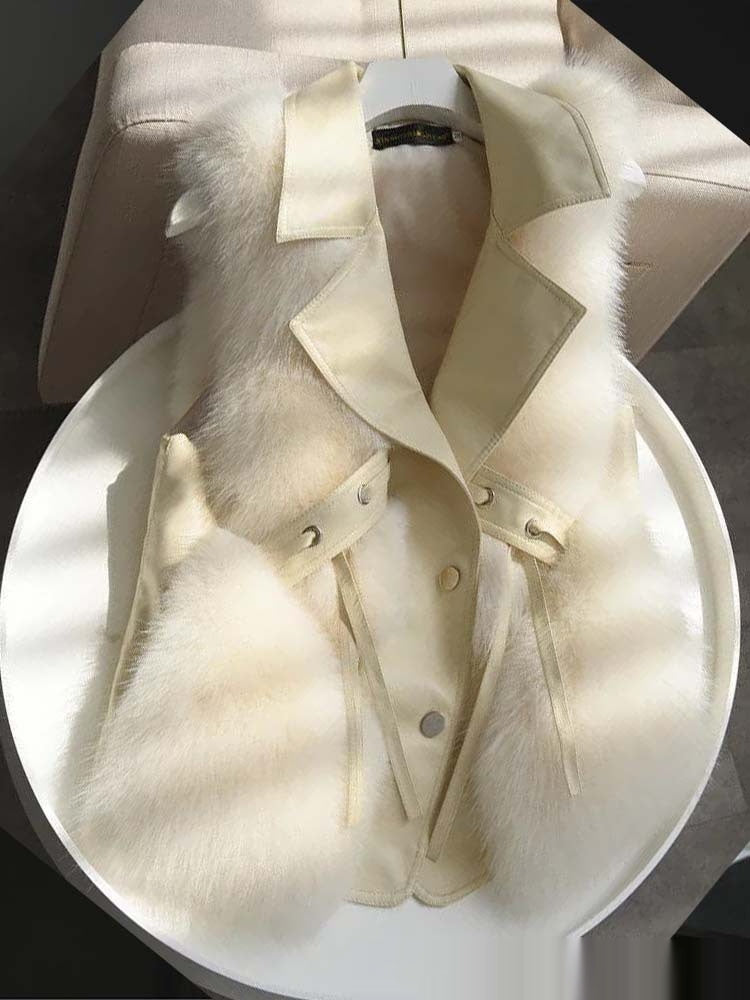 White fur coat with a fur collar on a mannequin against a white background