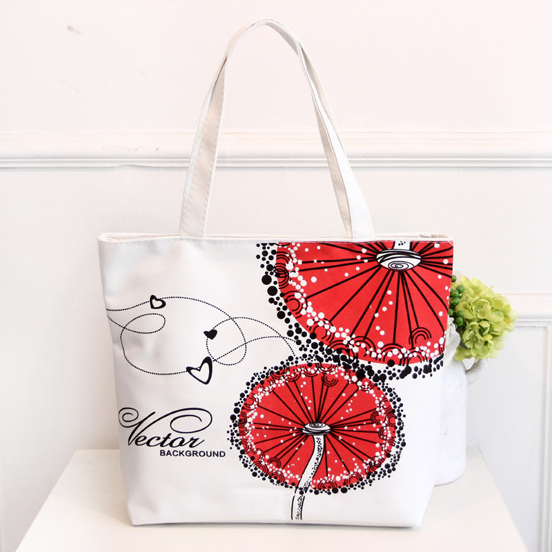White canvas tote bag with red circular graphic, heart lines, and small vector text