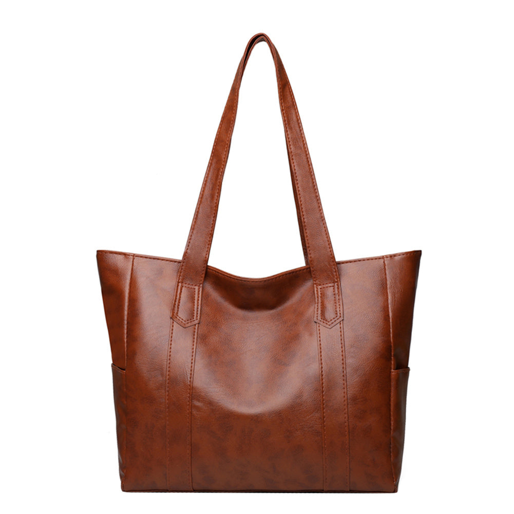 Large brown leather tote bag with two top handles and structured square body