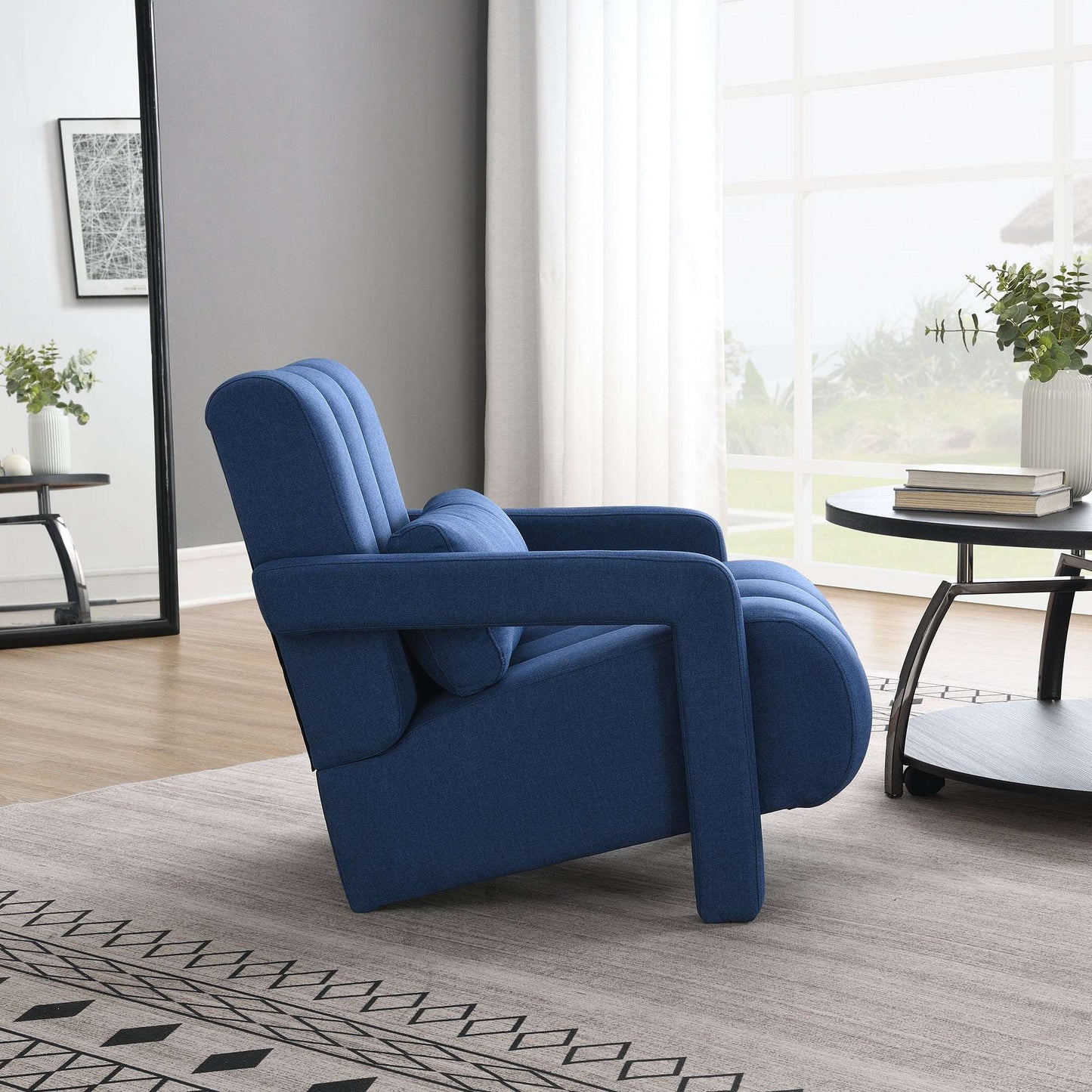 Dark blue upholstered accent chair with curved arms and layered back cushions