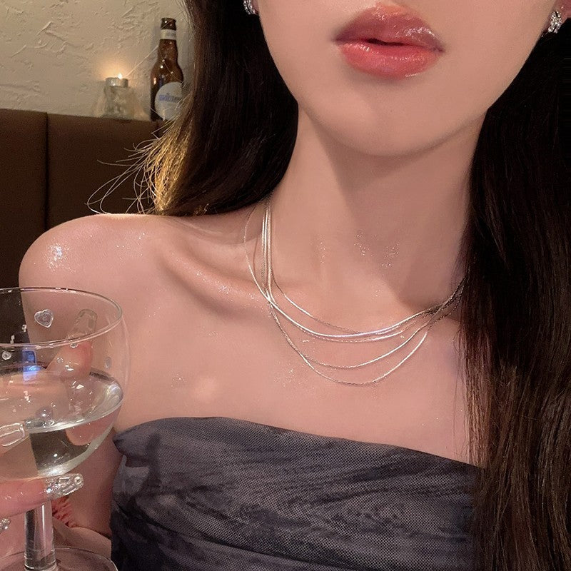 Layered pearl choker necklace set with slender chain and multiple pearl strands