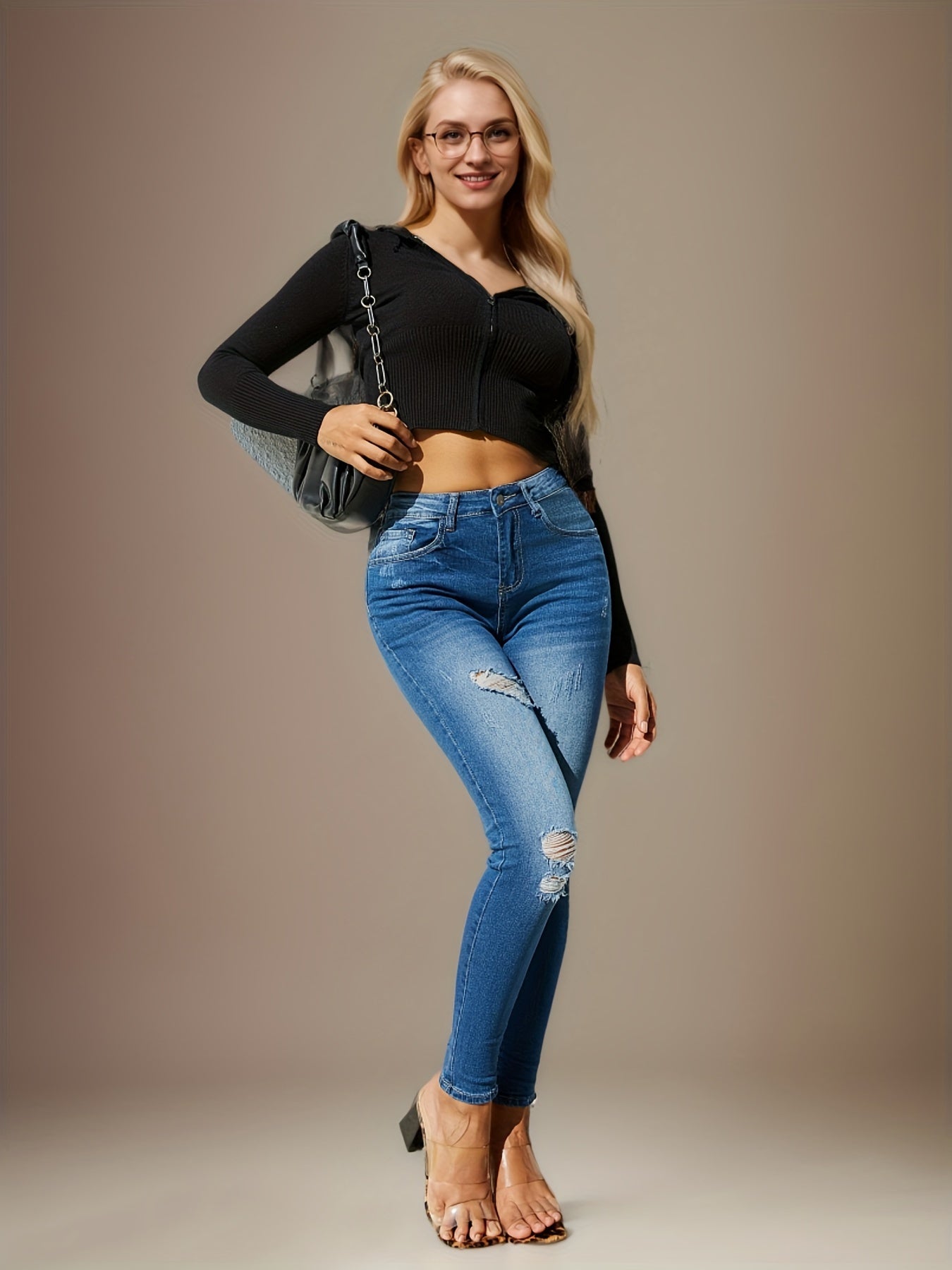 Blue high-waist skinny jeans with distressed knee and thigh rips