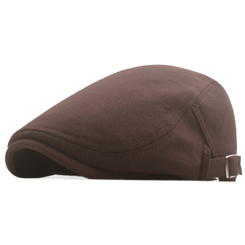 Brown newsboy cap with curved brim and adjustable strap, side profile