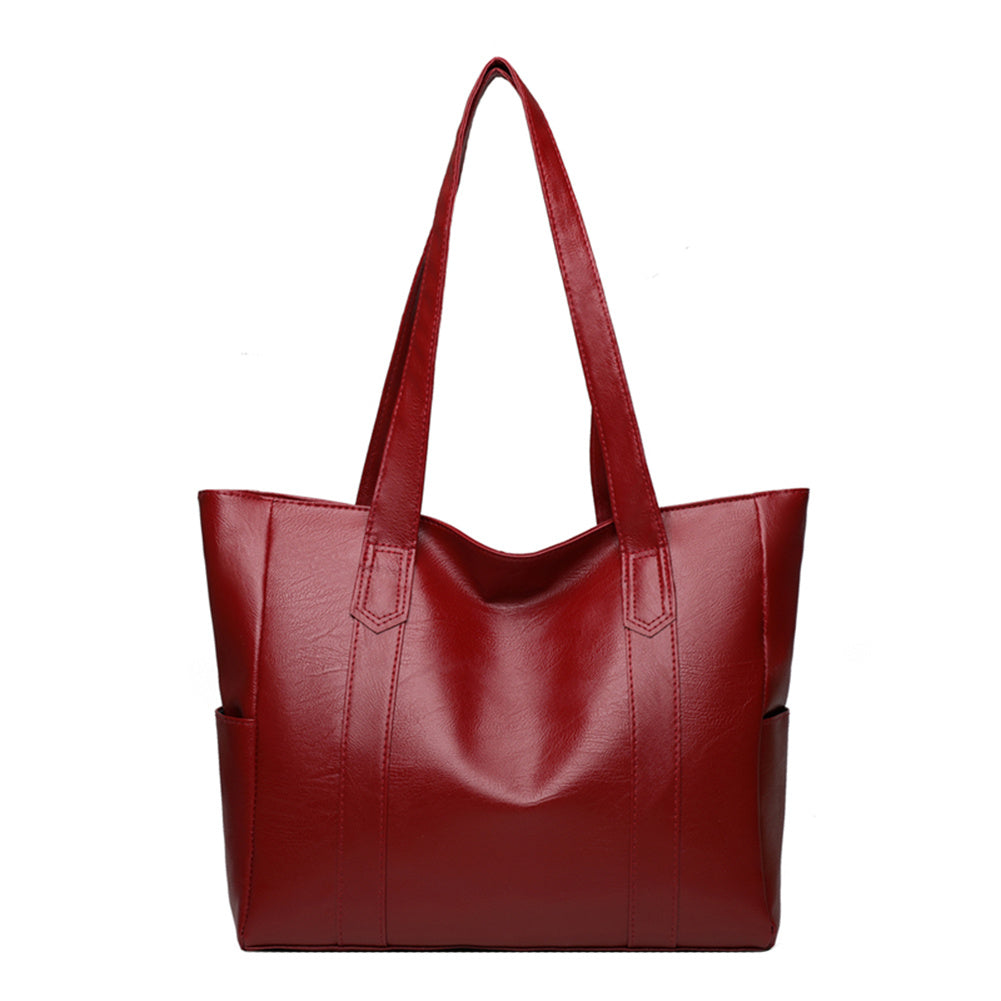 Red leather shoulder bag with wide top handles and side gussets