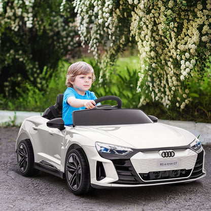 White kids ride-on car front three-quarter view with steering wheel; child seated
