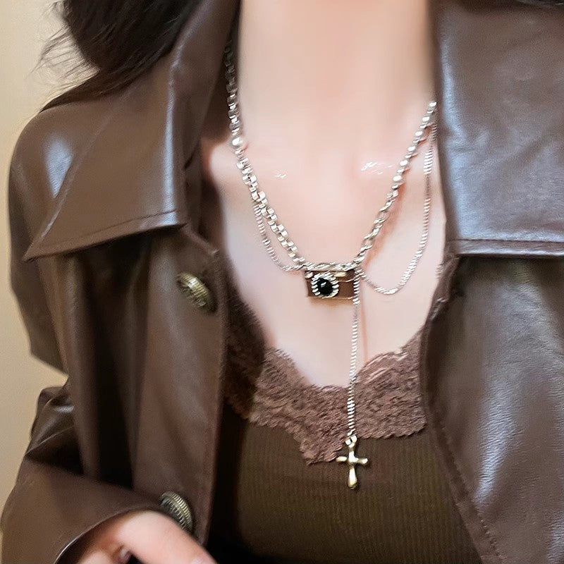 Silver-tone pearl chain necklace with layered strands and small charm drops