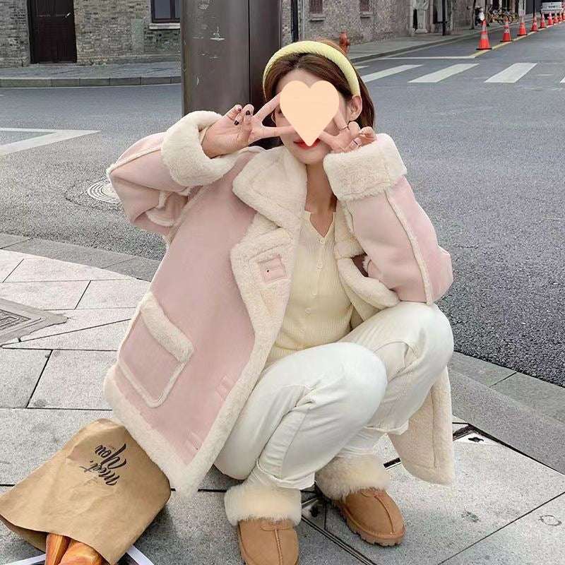 Women’s suede biker jacket in pale pink with cream sherpa trim and gold snap closures.