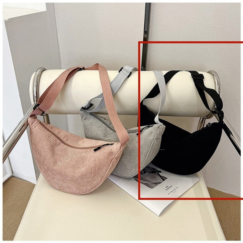 Blush pink and black large dumpling crossbody bags with adjustable straps