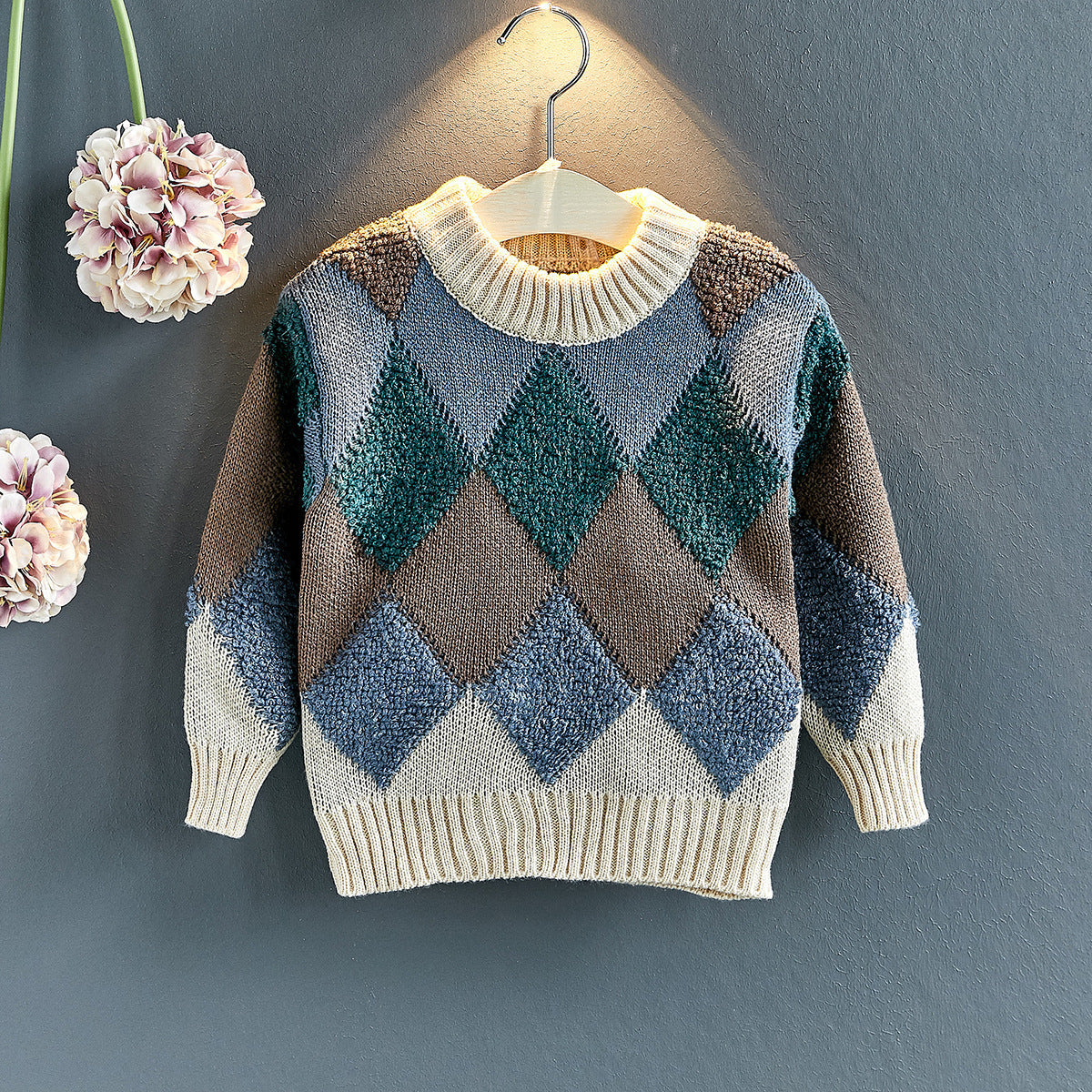 Crew-neck argyle knit pullover with ribbed hem; blue and teal diamonds with dark brown accents.
