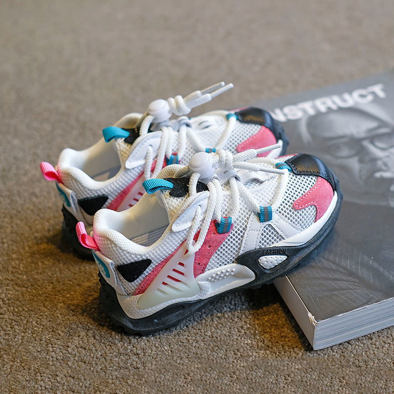 Kids white sneakers with light-blue sides and bright orange lace tips, gray sole