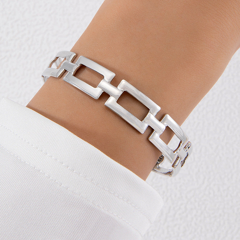Geometric link letter bow bracelet in silver-tone metal, adjustable fit