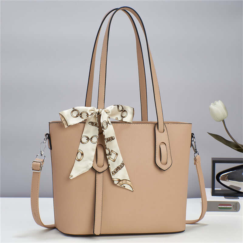 Beige fashion tote handbag with scarf tie, top handles, and side pockets