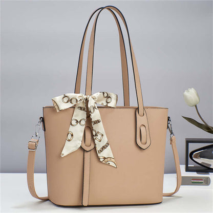 Beige fashion tote handbag with scarf tie, top handles, and side pockets