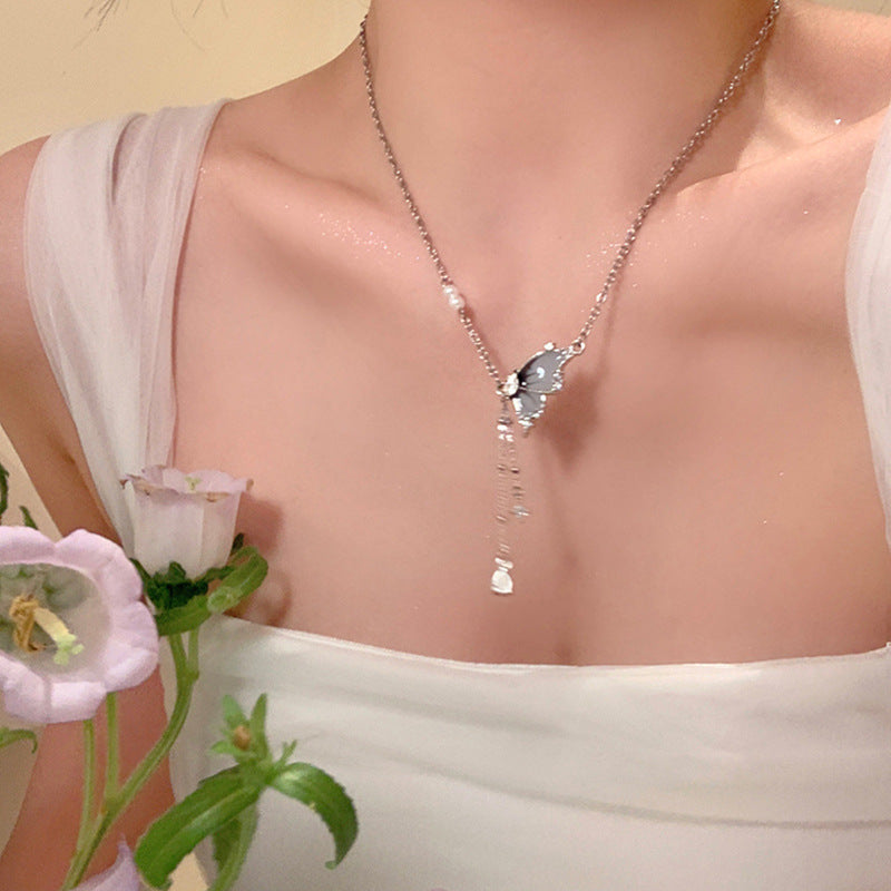 Butterfly pearl pendant necklace with delicate chain and small dangling pearl drop