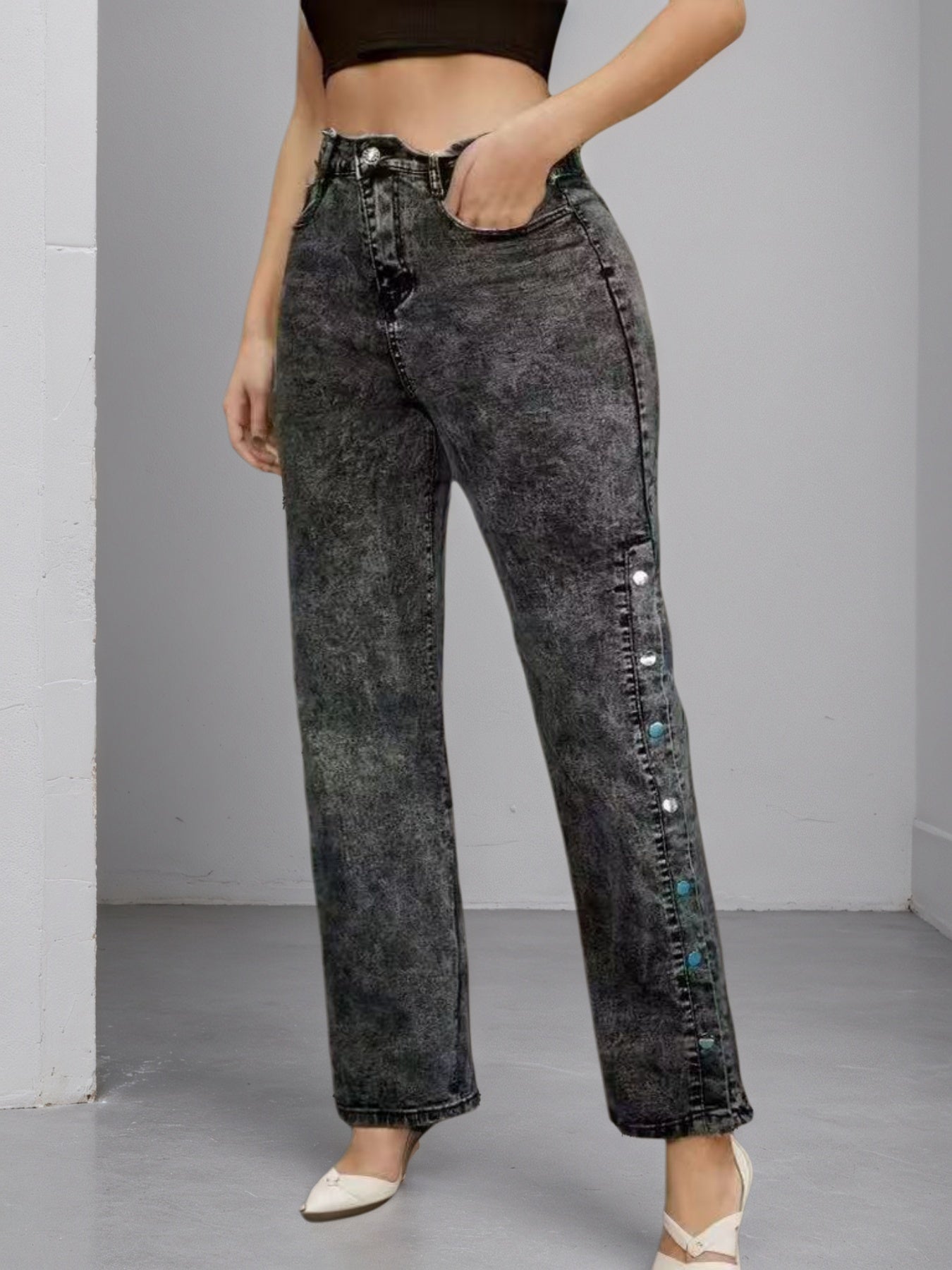 High-waisted dark jeans with slightly flared leg, side buckle hardware and studs