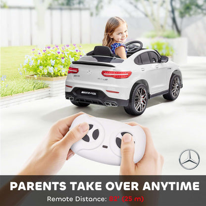 White kids 12V ride-on SUV rear view; child seated while adult holds remote