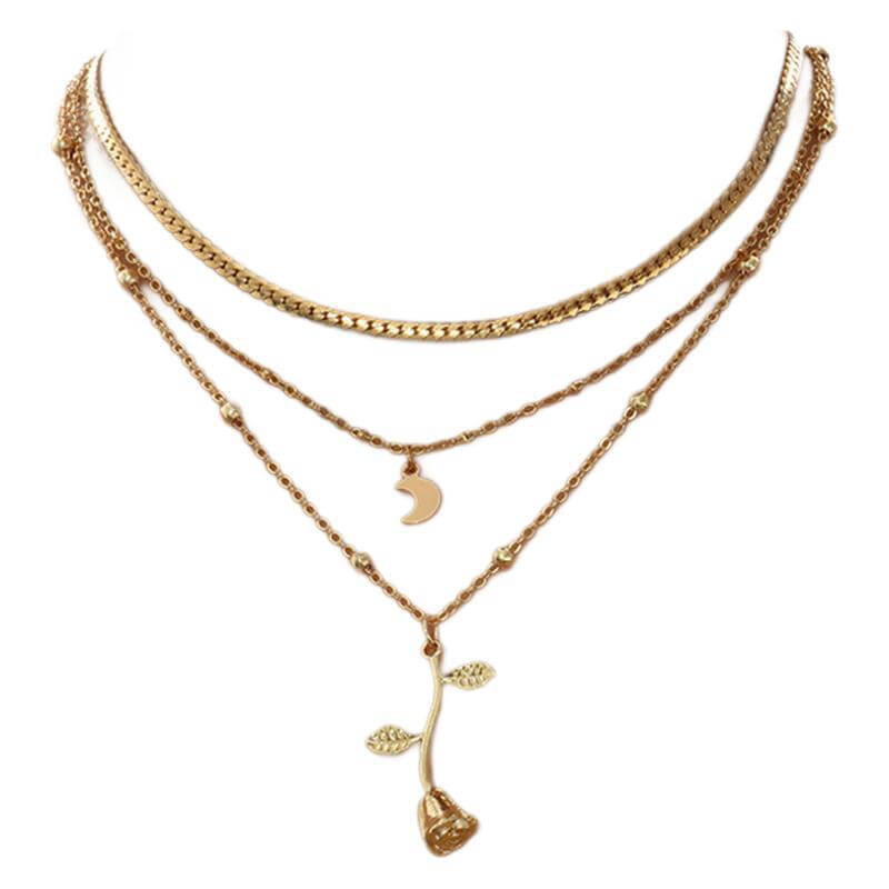Gold necklace with multiple layers and floral pendant on a white background