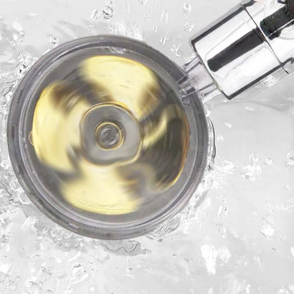 Round shower head nozzle with swirling spray pattern
