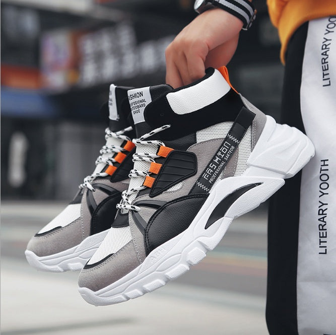 Black and gray high-top sneakers with white sole and orange strap details