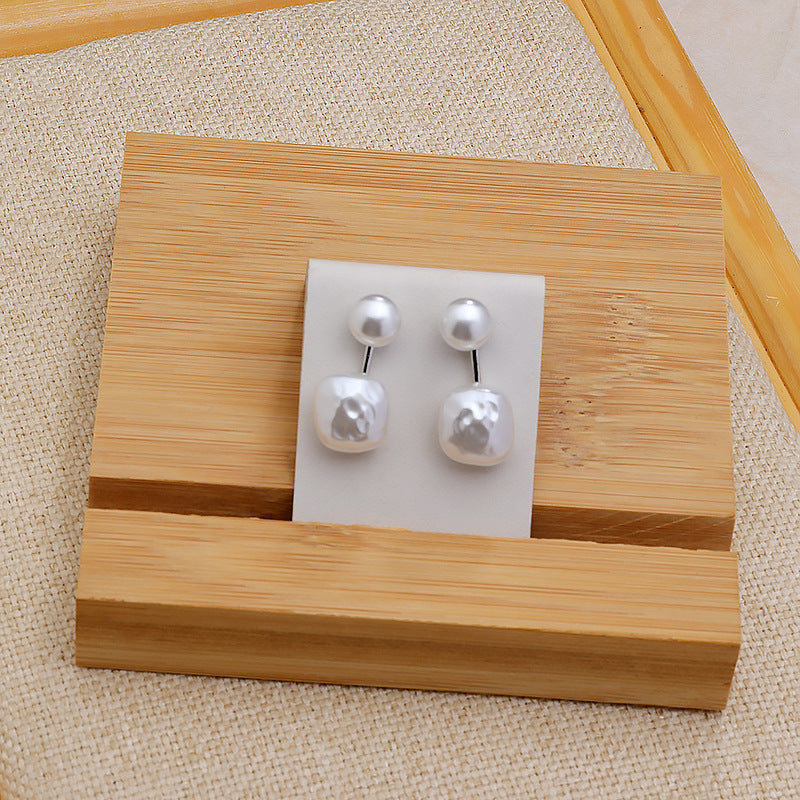 Pearl ear studs with round top pearls and irregular white drop pearls, gold-toned posts