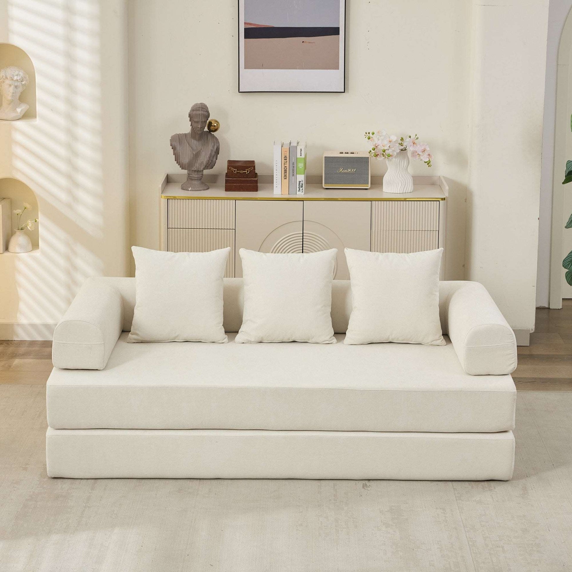 Beige convertible sofa bed front view with three back pillows and curved armrests