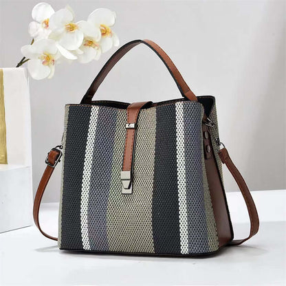 Large crossbody handbag in dark gray with white vertical stripes and brown top handles