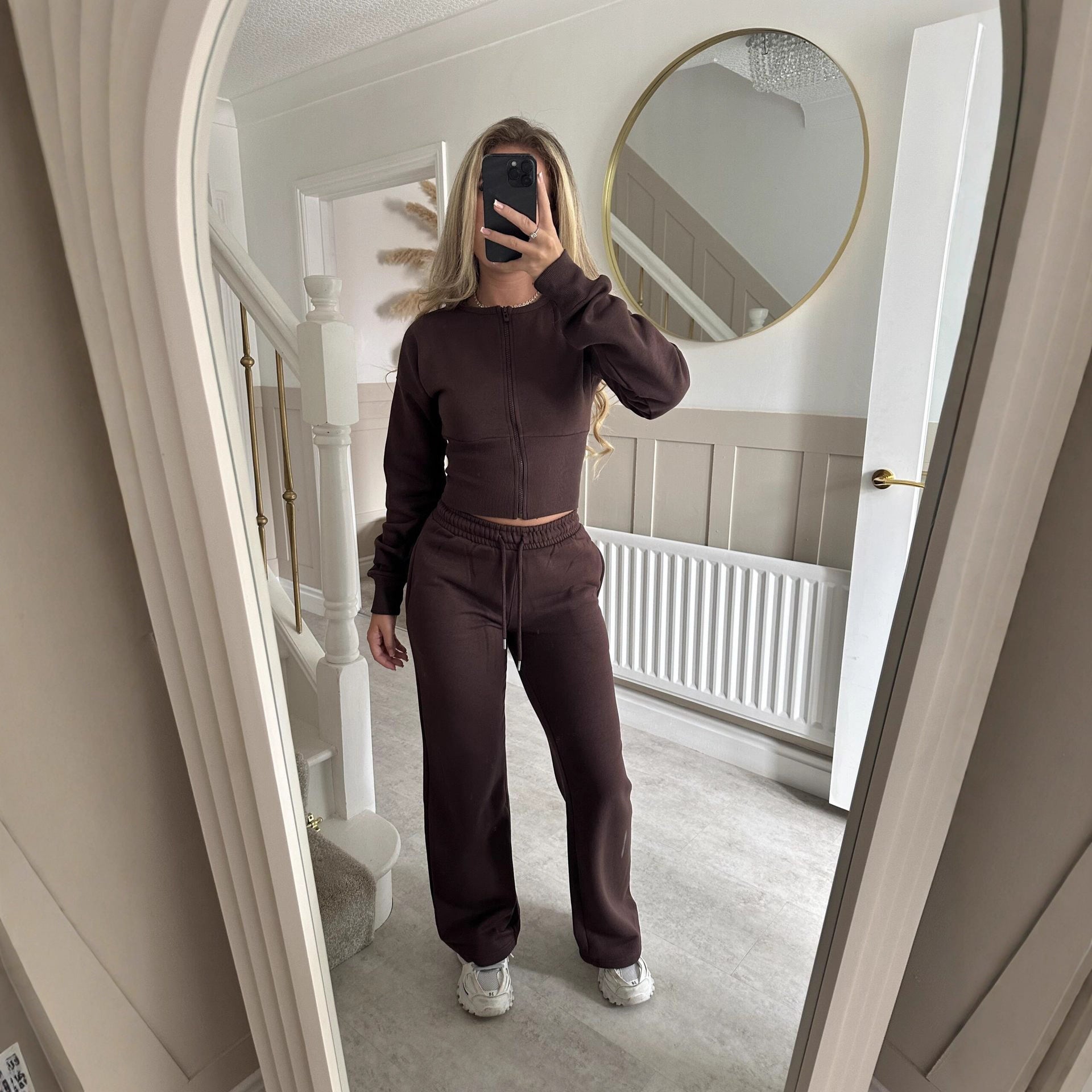 Women’s zip-front sweatshirt and jogger set in dark brown, two-piece outfit.