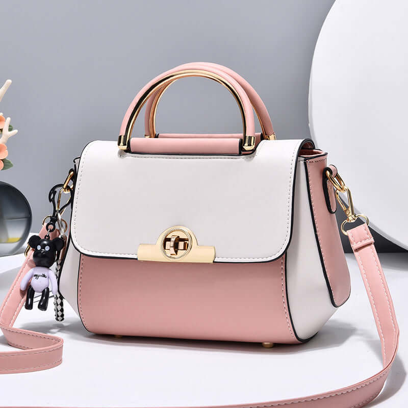 Lightweight crossbody bag with white and pink colorblock, top handle, flap, gold clasp