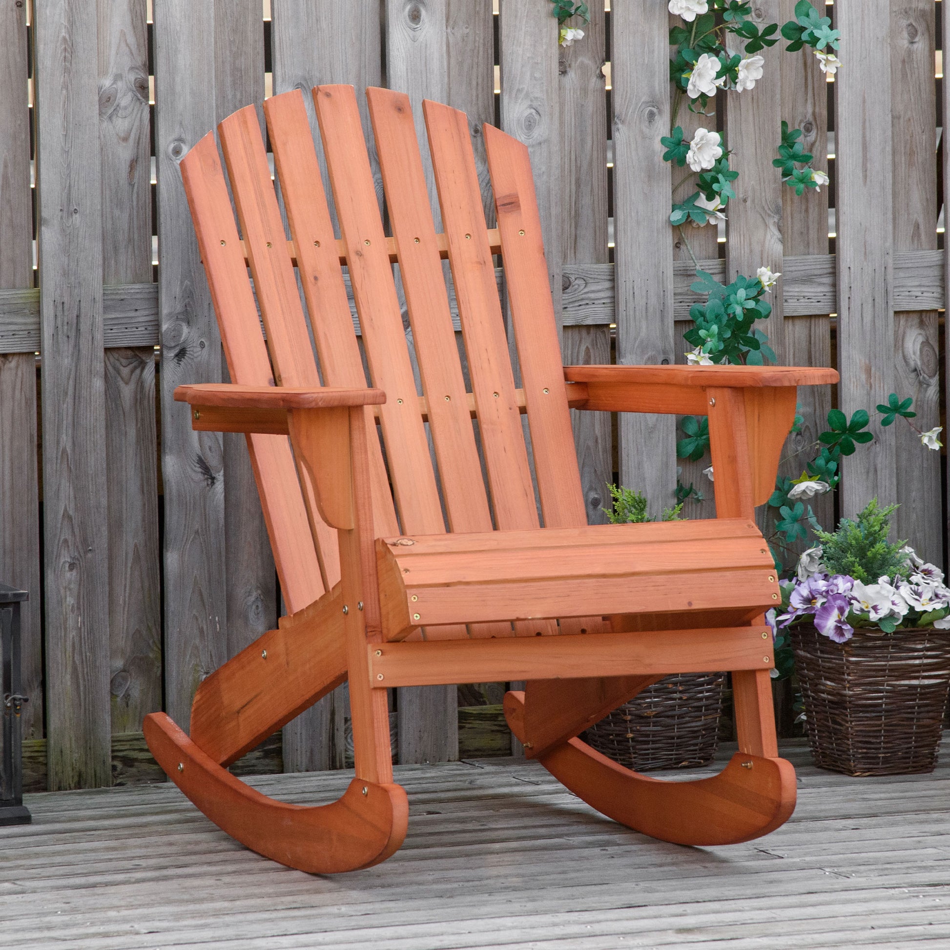 Teak wood Adirondack rocking chair with wide slatted back and curved rocking base.