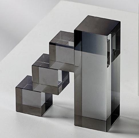 Smoky gray crystal ladder bookends with stacked mirrored blocks, angled view