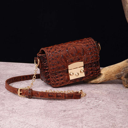 Rust brown croc-textured crossbody bag with flap and gold-tone lock hardware