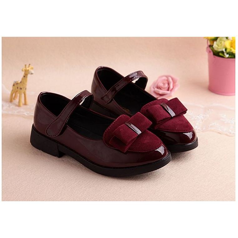 Kids leather school sneakers in dark wine red with center bow-like buckle and flat sole
