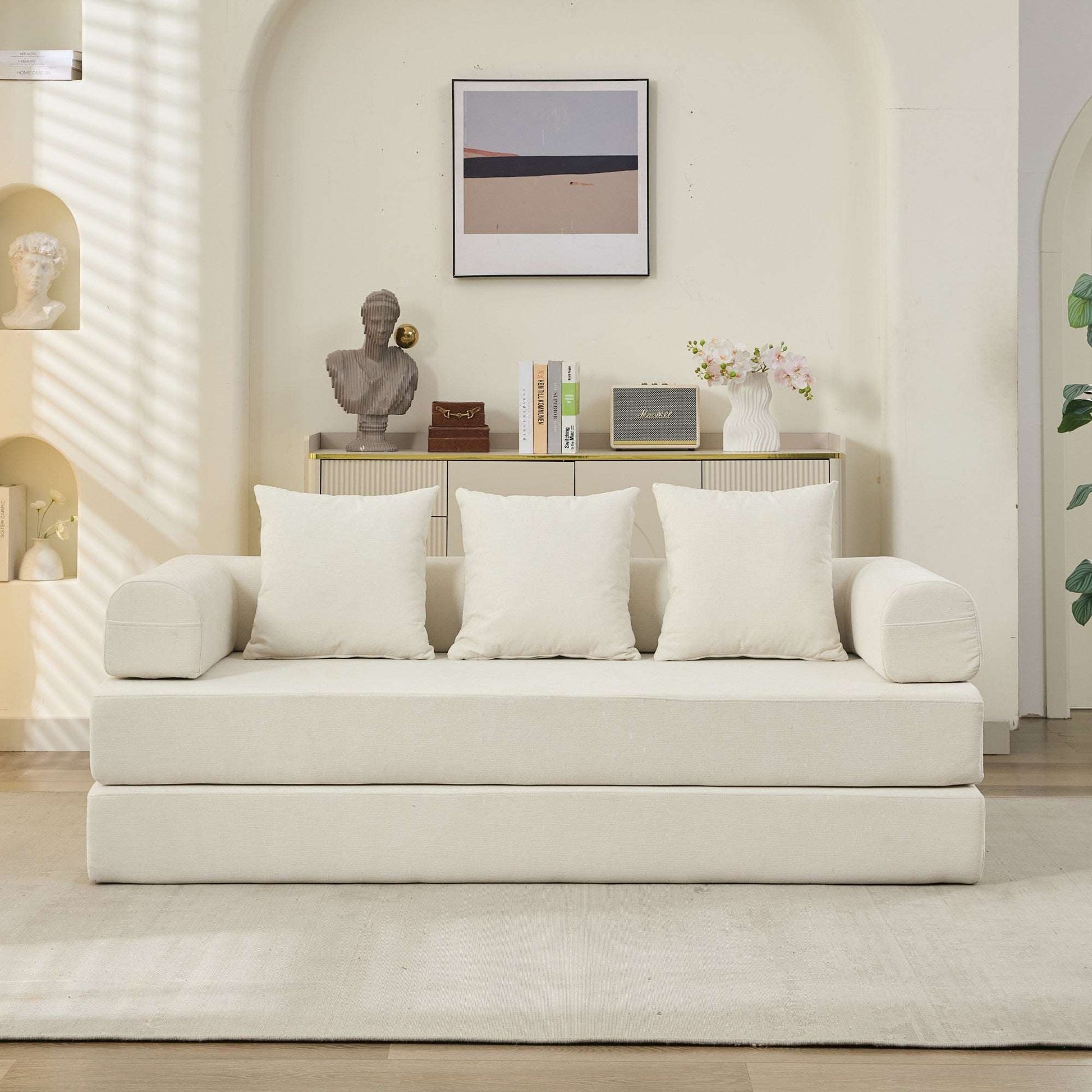 Beige convertible sofa bed front view with three back pillows and matching arm cushions