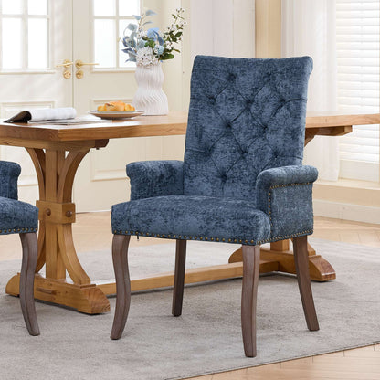 Blue upholstered accent dining chair with tufted back, rolled arms, and wood legs