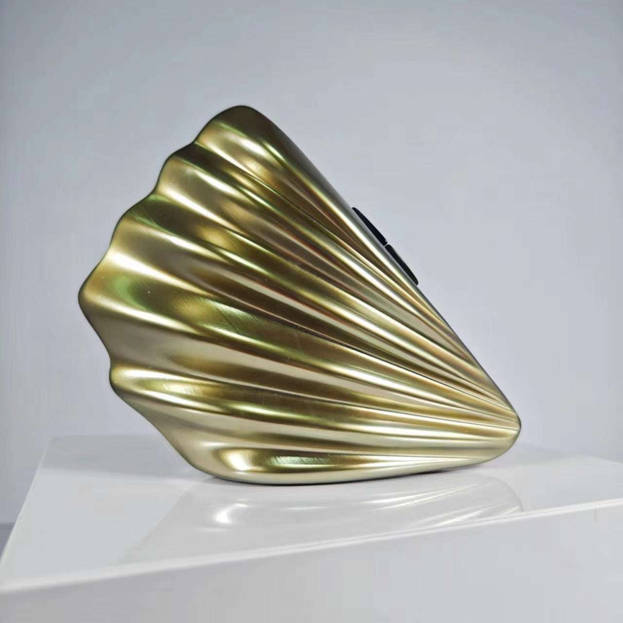 Metallic gold-green shell crossbody bag with glossy ridged design