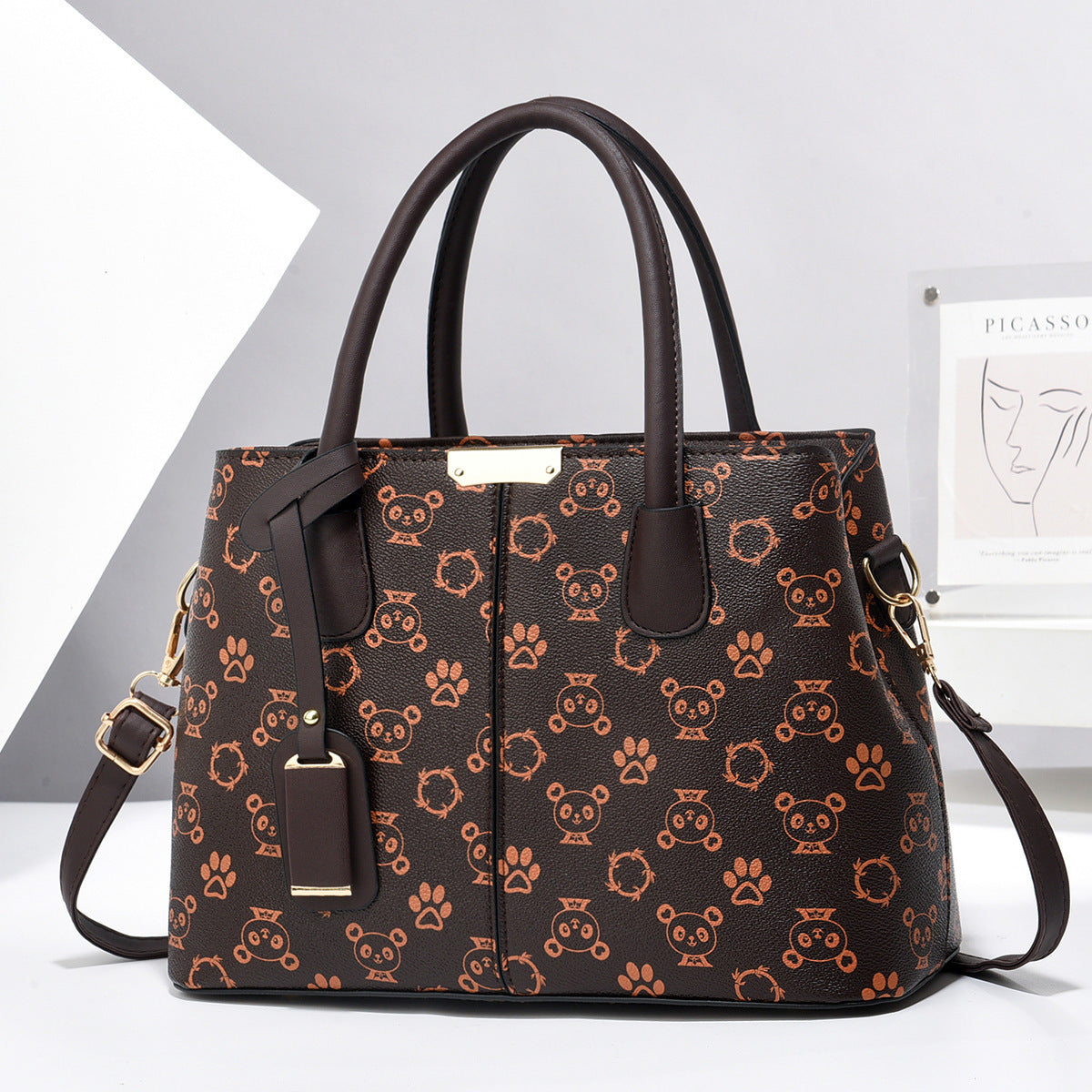 PU leather tote bag with top handles and crossbody strap, dark brown with orange print