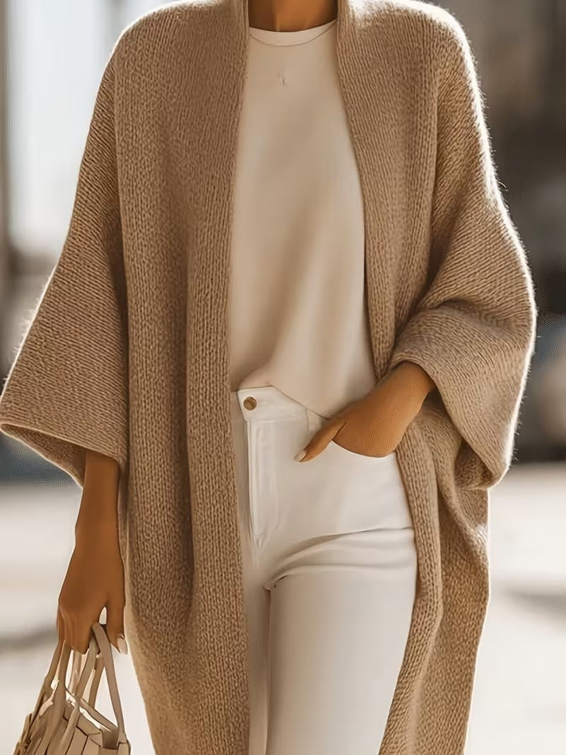 Tan knitted shawl jacket with draped front, open neckline, and short batwing sleeves