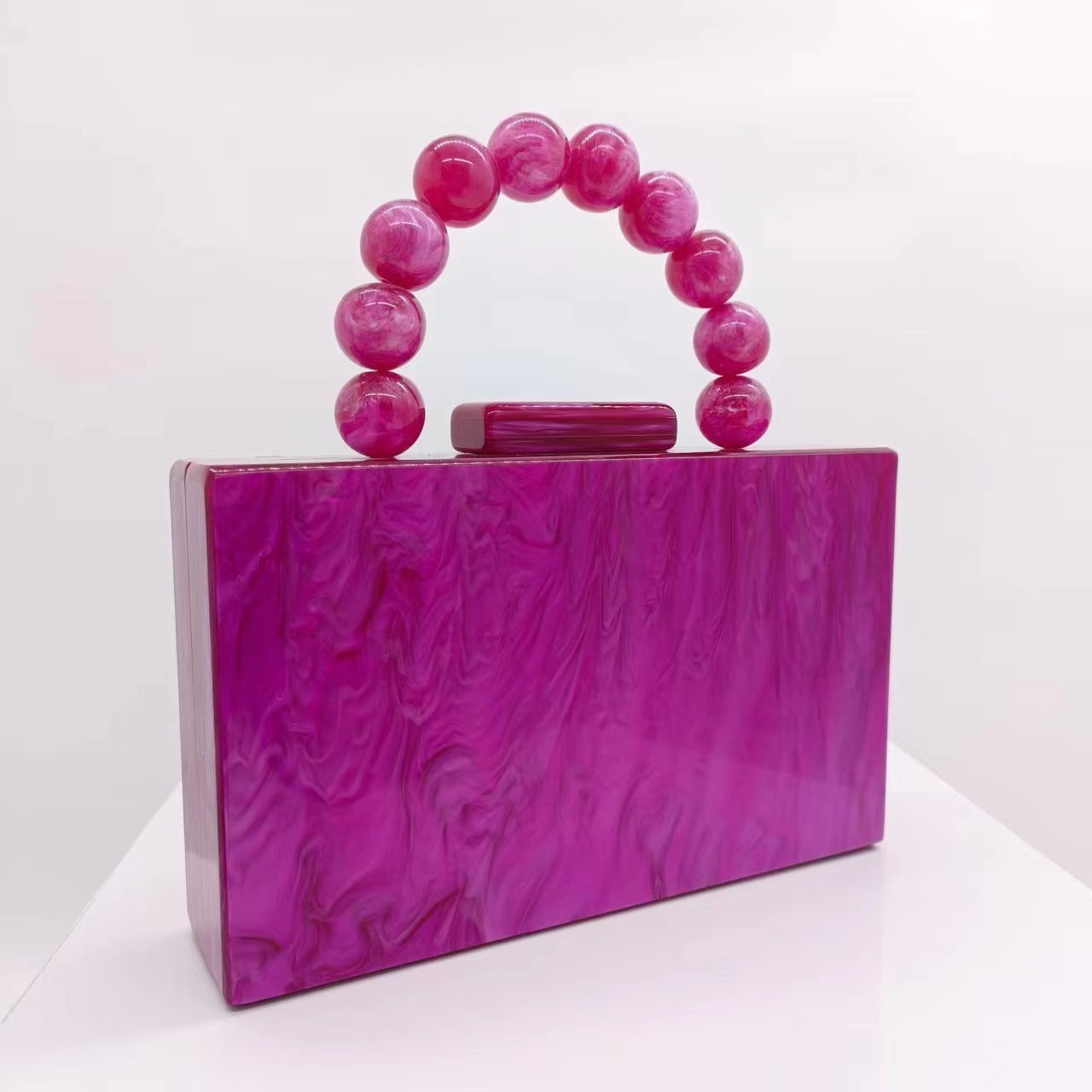 Magenta purple acrylic evening bag with round beaded handle and top bar clasp