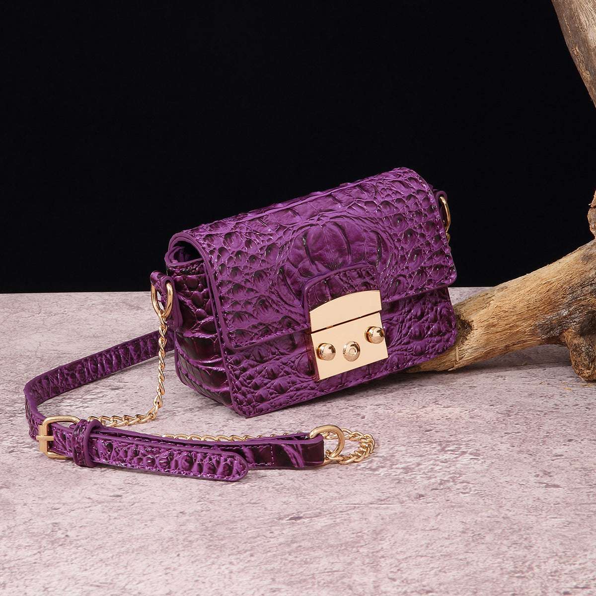 Purple croc-textured crossbody bag with flap and gold-tone lock hardware
